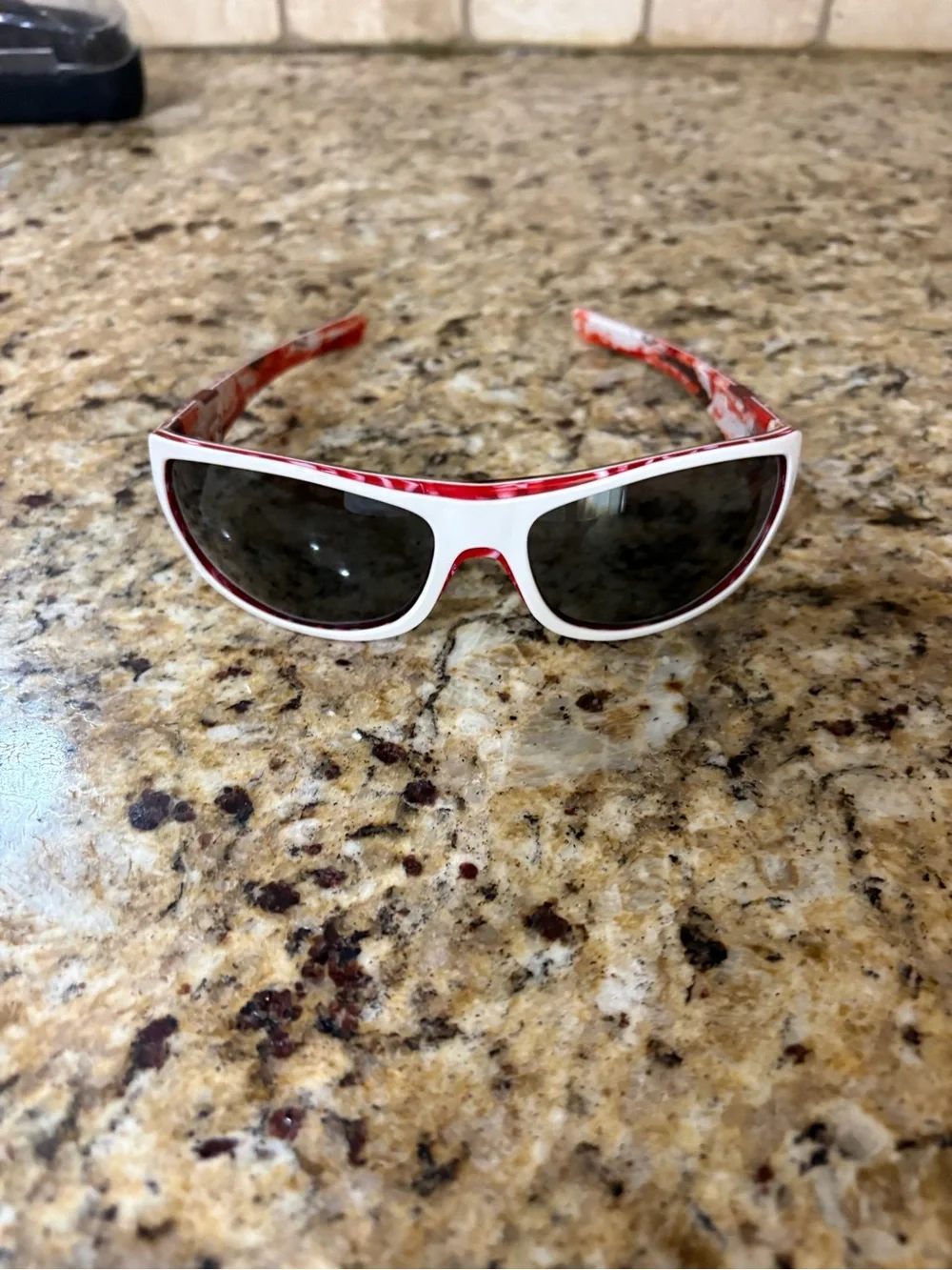 Oakley White Frame Sunglasses with Red Patterned Temples and Dark Lenses